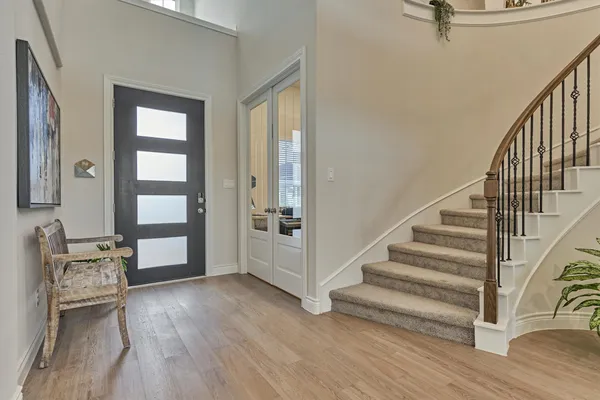 a view of an entryway with wooden floor and windows
