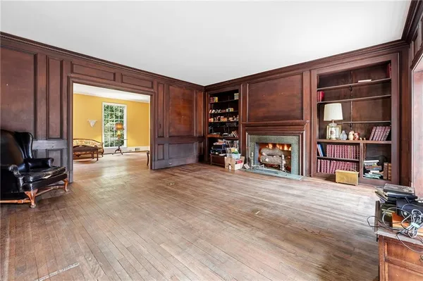 a view of empty room with wooden floor and cabinet
