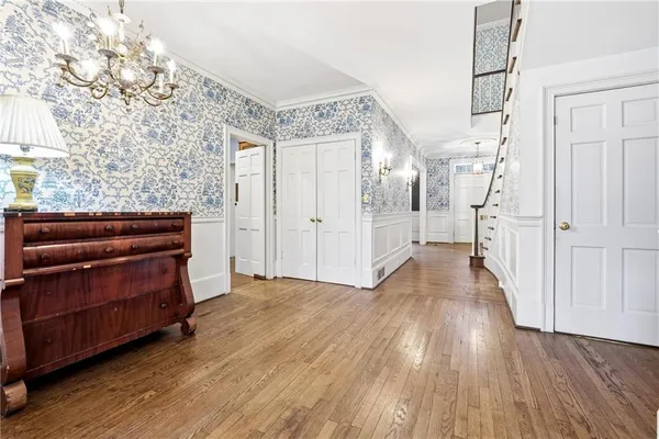 a kitchen with stainless steel appliances granite countertop a refrigerator a stove and a wooden floors
