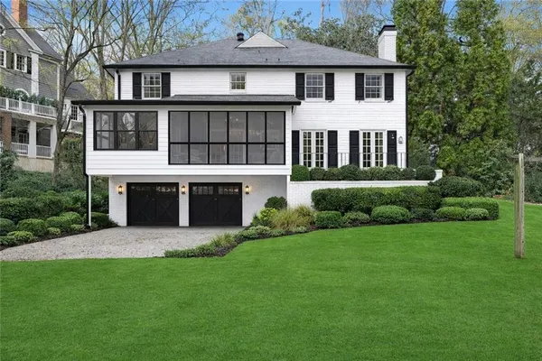 a front view of a house with yard and porch