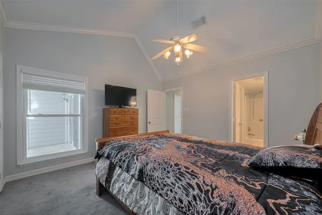 a bedroom with a large bed and a tv