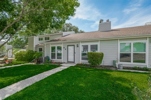 a view of a house with a backyard