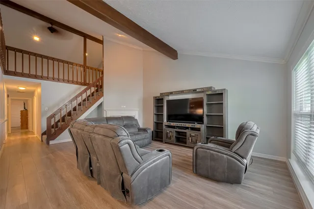 a living room with furniture and a flat screen tv