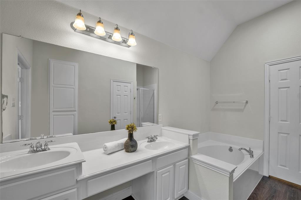 3585 Navarro Way Frisco, TX 75034 - Photo 13 of 18 Ensuite primary bath with garden tub and walk-in shower.