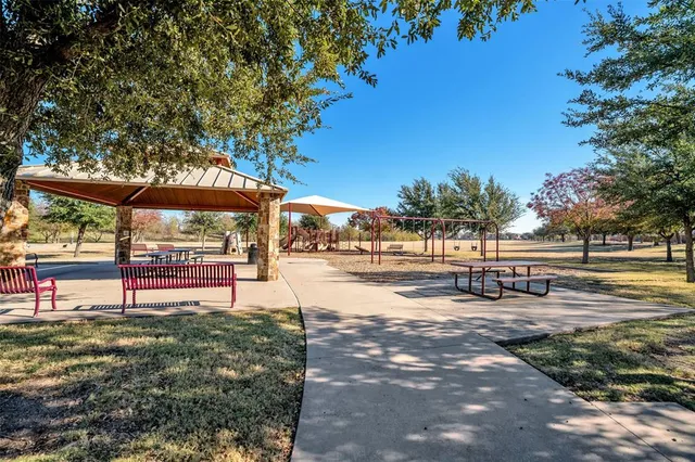 a view of a park with swings and slides
