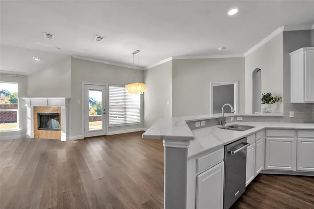 a kitchen with a sink and a stove top oven