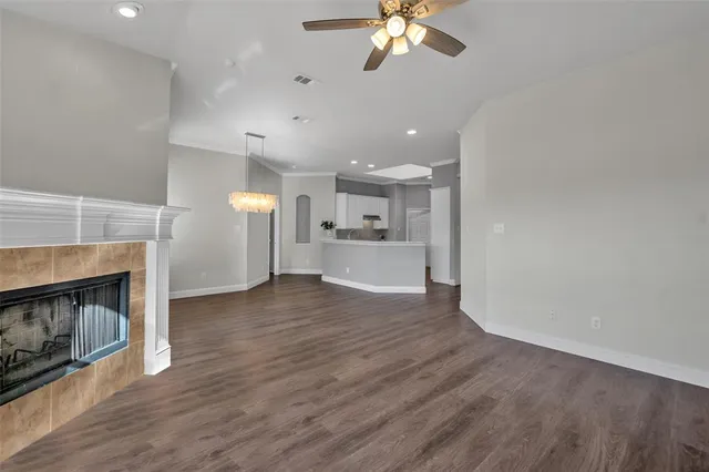 a view of a room with wooden floor and fire place