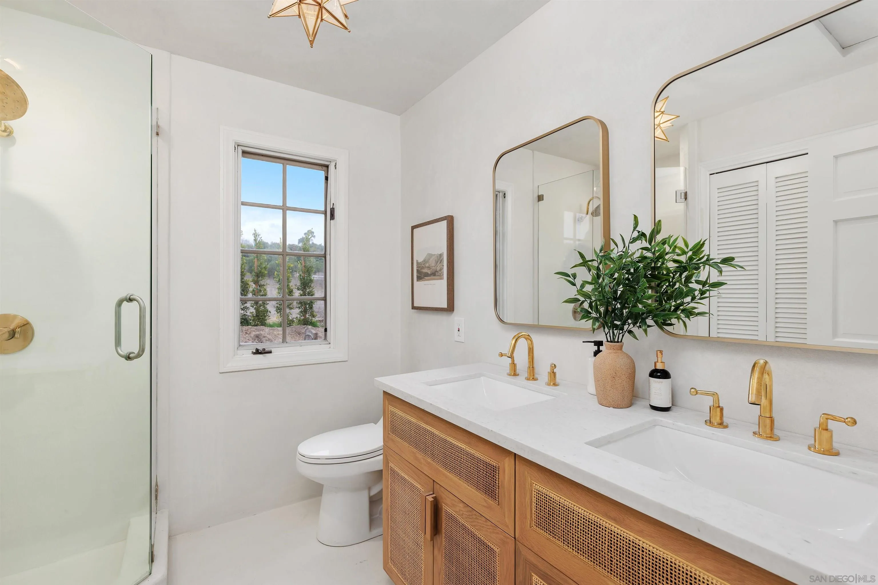 6631 Lago Lindo Rancho Santa Fe, CA 92067 - Photo 12 of 14 a bathroom with a toilet sink and mirror