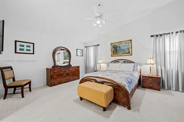 a spacious bedroom with a bed and a chandelier