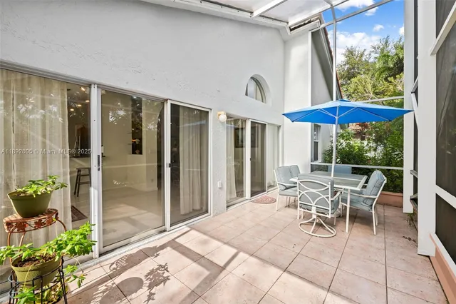 a view of a patio with table and chairs potted plants with wooden floor
