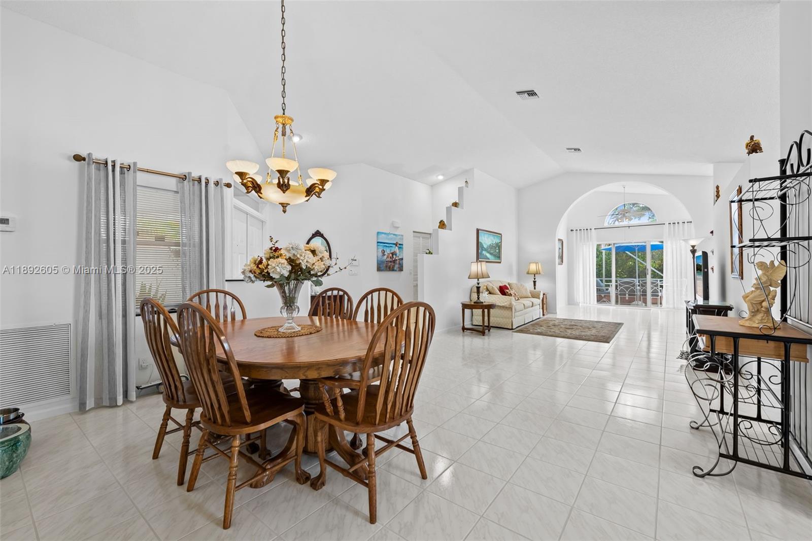 9650 Harbour Lake Circle Boynton Beach, FL 33437 - Photo 3 of 25 a dining room with furniture a chandelier and window