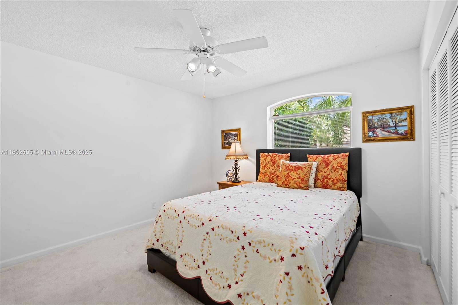 9650 Harbour Lake Circle Boynton Beach, FL 33437 - Photo 10 of 25 a bedroom with a bed and a chandelier