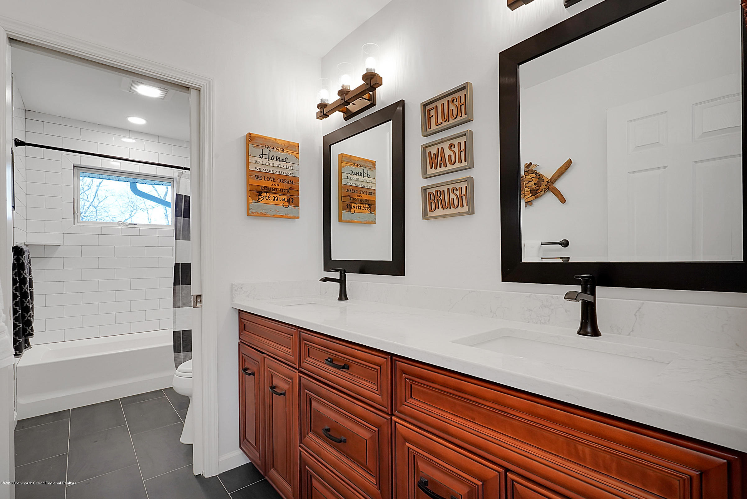 2411 Apple Ridge Circle Manasquan, NJ 08736 - Photo 19 of 37 a bathroom with a sink a vanity and mirror