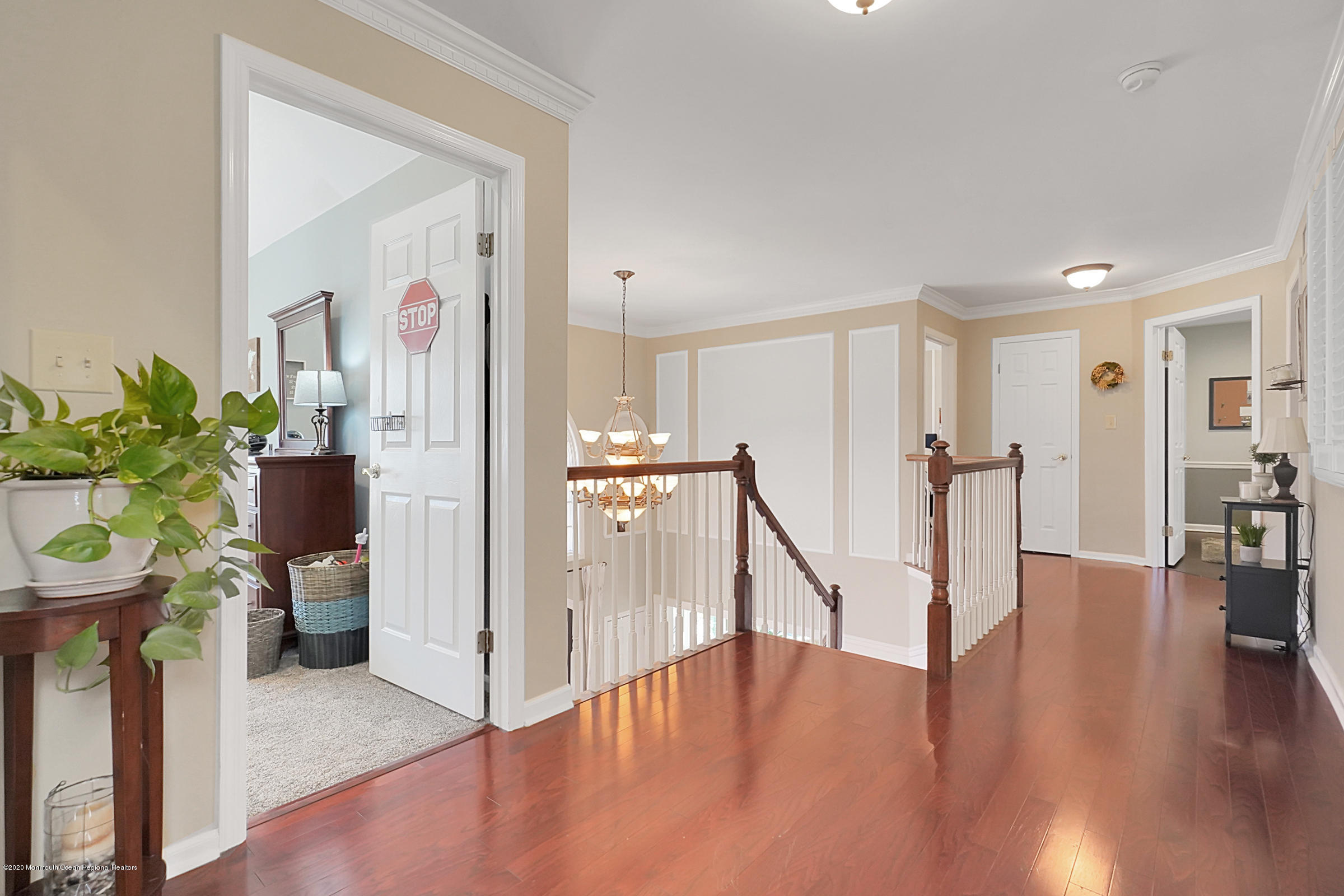 2411 Apple Ridge Circle Manasquan, NJ 08736 - Photo 20 of 37 a view of a hallway with wooden floor and stairs