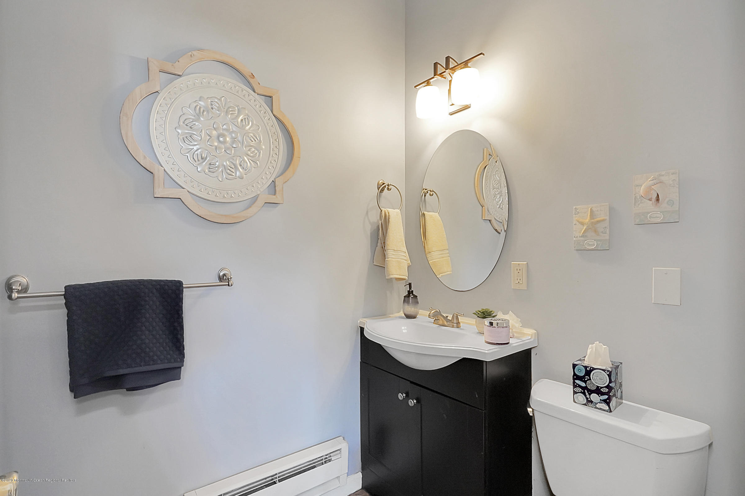2411 Apple Ridge Circle Manasquan, NJ 08736 - Photo 31 of 37 a bathroom with a toilet sink and mirror