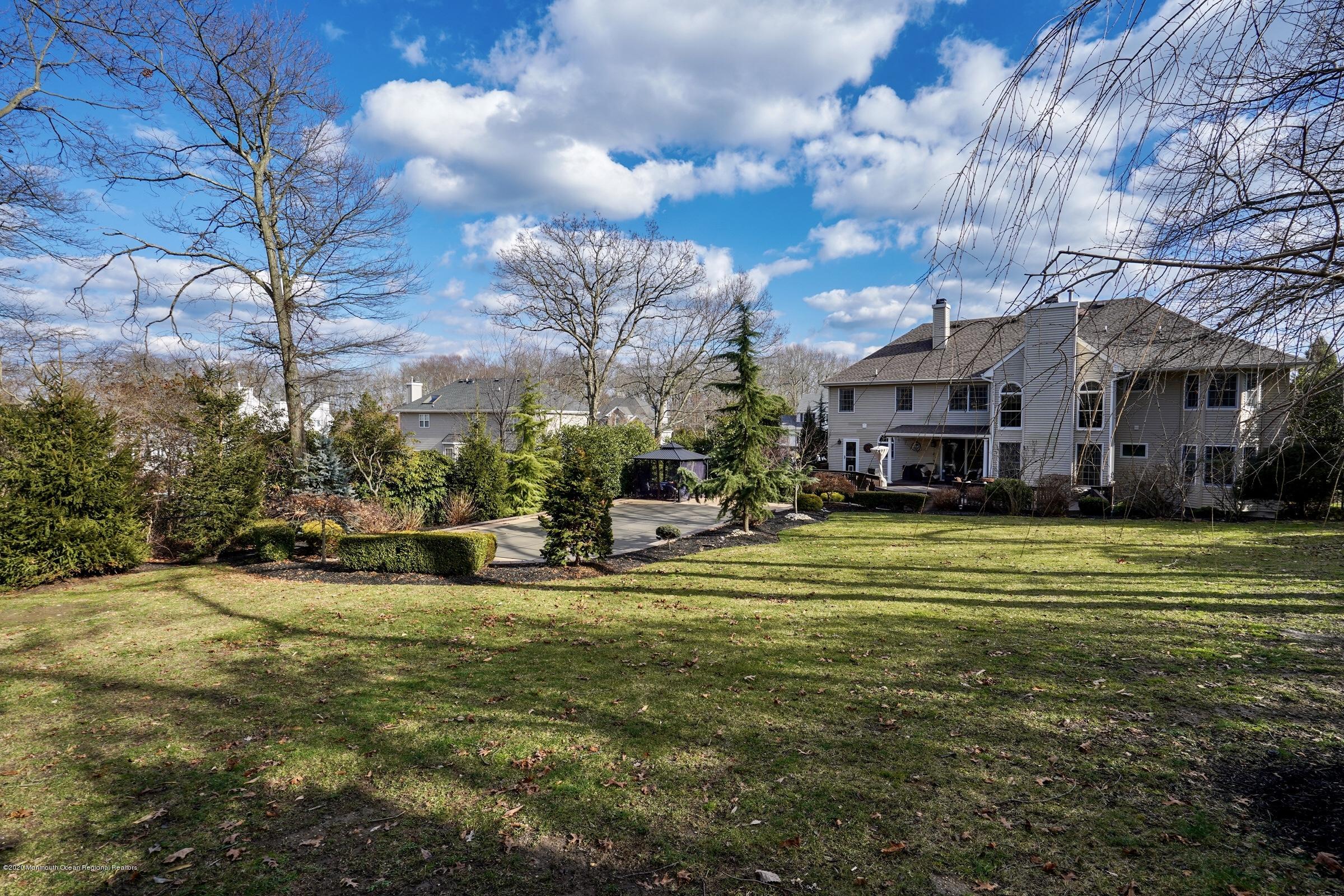 2411 Apple Ridge Circle Manasquan, NJ 08736 - Photo 35 of 37 a view of a swimming pool with outdoor seating