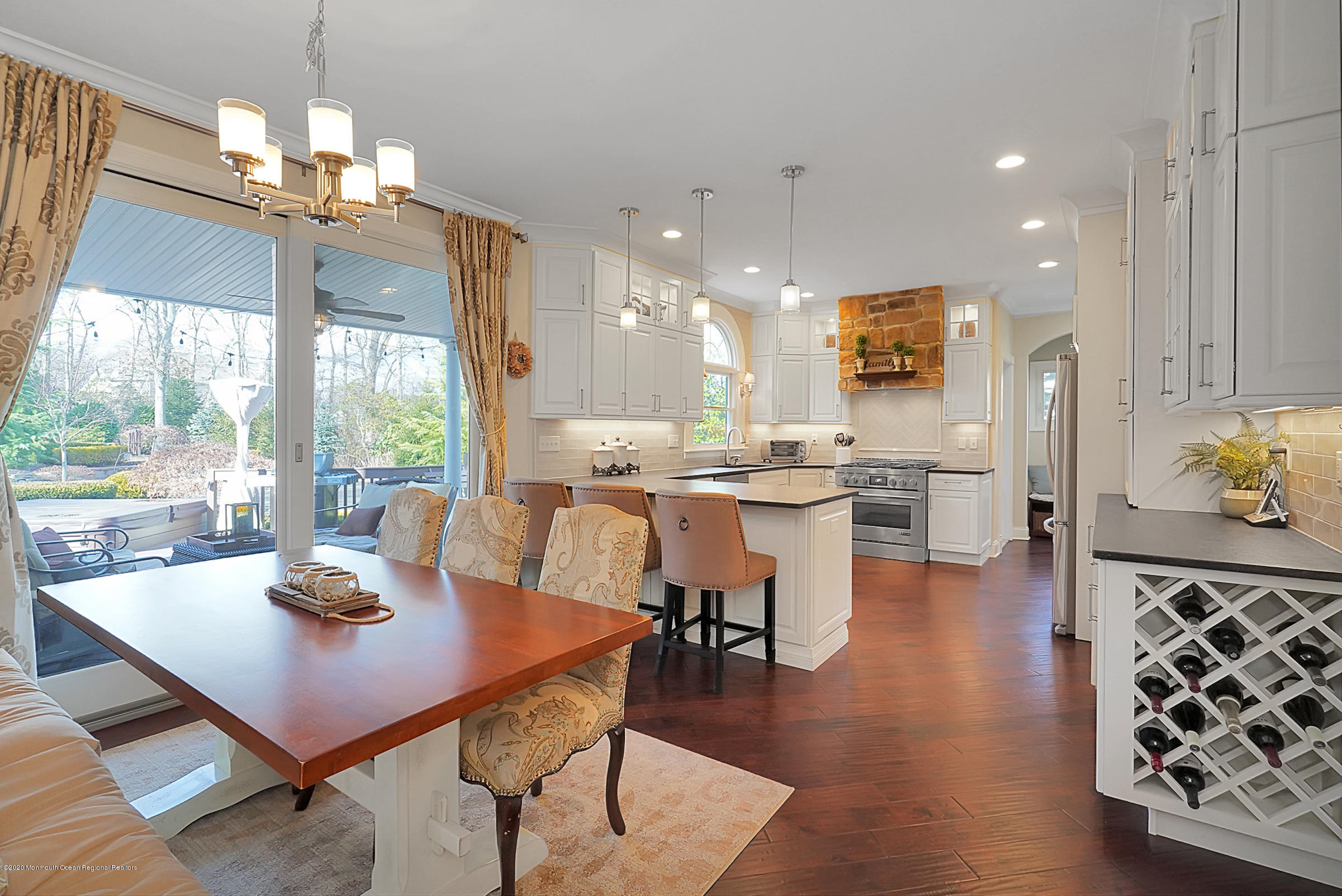 2411 Apple Ridge Circle Manasquan, NJ 08736 - Photo 9 of 37 a dining room with furniture a large window and wooden floor