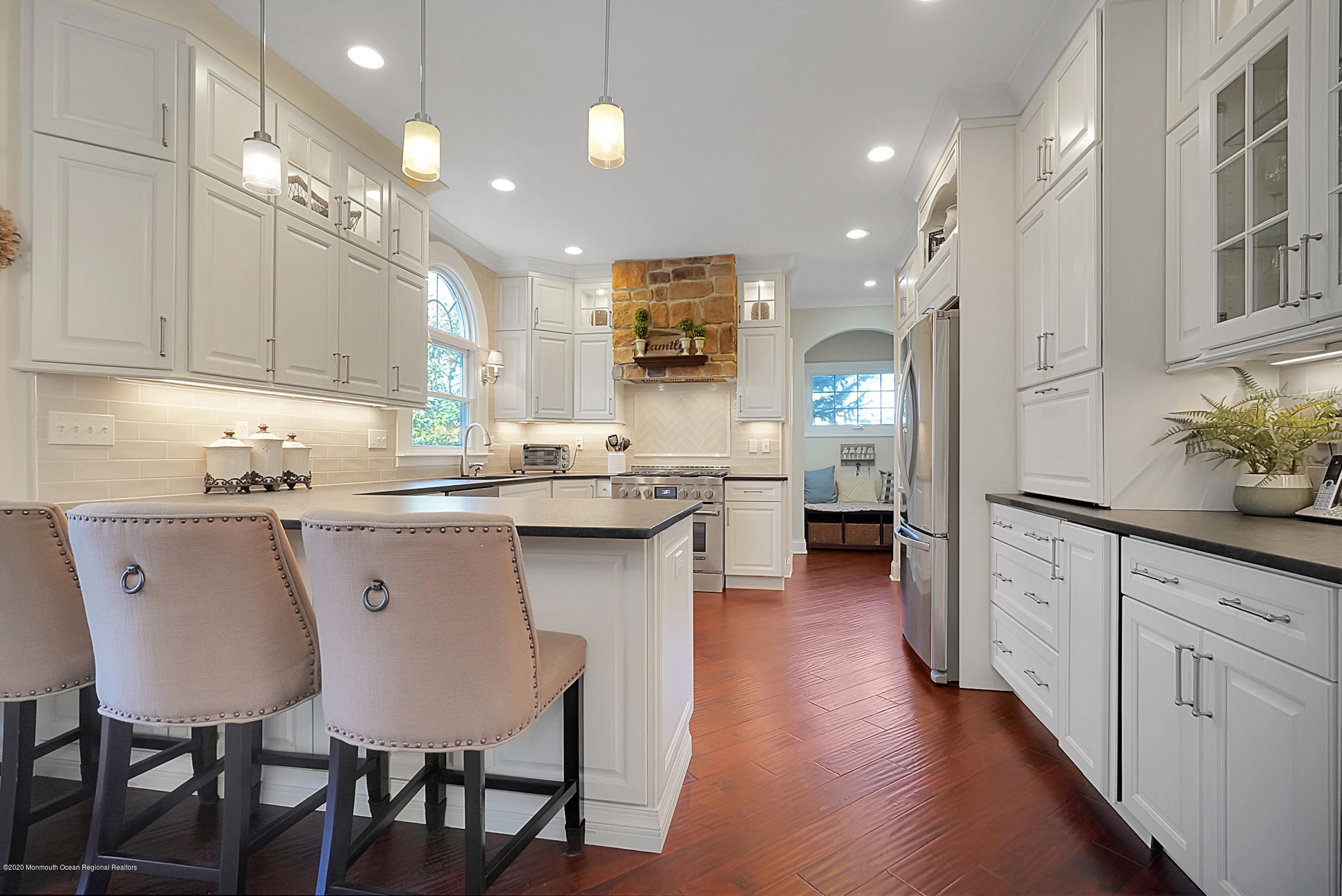 2411 Apple Ridge Circle Manasquan, NJ 08736 - Photo 10 of 37 a kitchen with stainless steel appliances a dining table chairs stove refrigerator and cabinets