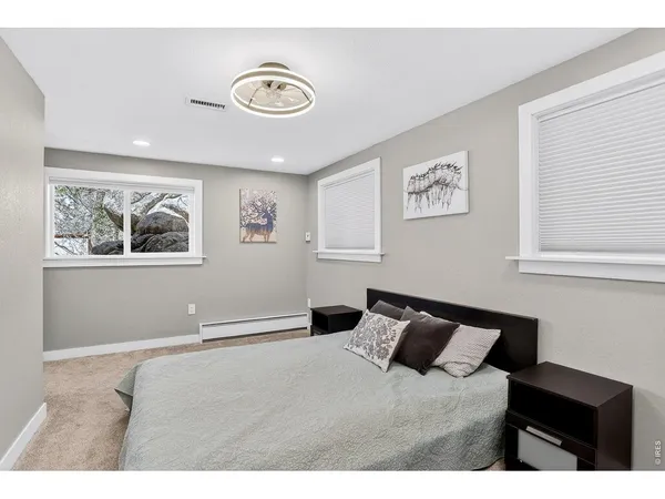 a bedroom with a bed and a lamp