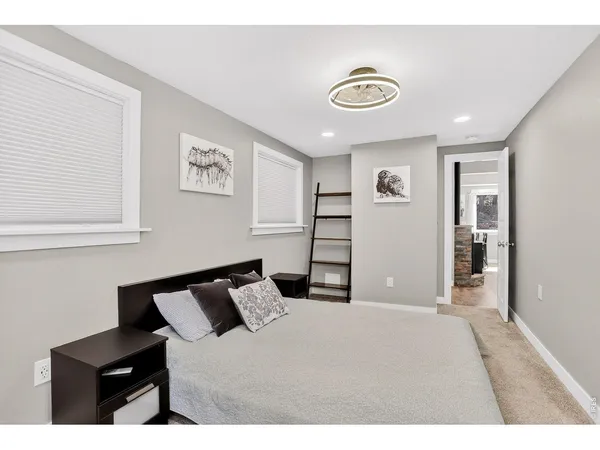 a bedroom with a bed and a lamp