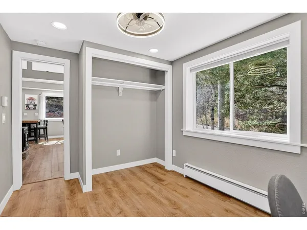 a view of a hallway with wooden floor and entryway