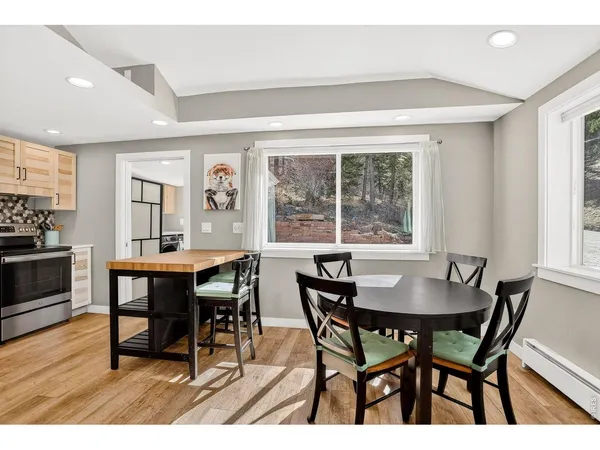a dining room with furniture and wooden floor