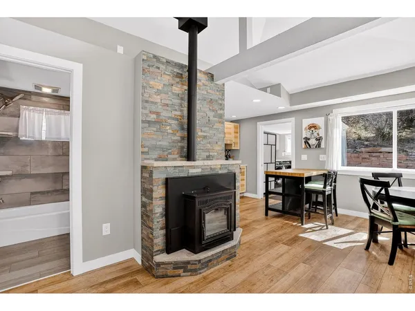 a living room with furniture a fireplace and a table