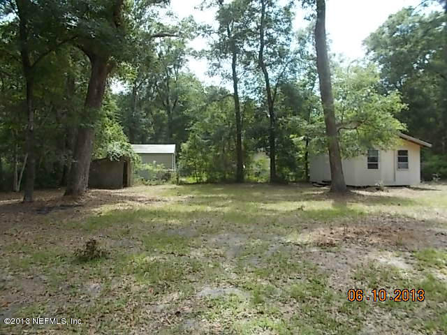96539 Blackrock Road Yulee, FL 32097 - Photo 14 of 26 a view of a house with backyard and trees