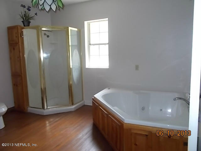 96539 Blackrock Road Yulee, FL 32097 - Photo 20 of 26 a bathroom with a tub and shower
