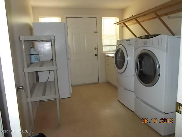 96539 Blackrock Road Yulee, FL 32097 - Photo 22 of 26 a view of a hallway with washer and dryer