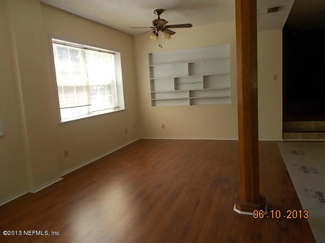 96539 Blackrock Road Yulee, FL 32097 - Photo 25 of 26 an empty room with wooden floor and windows