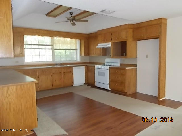 96539 Blackrock Road Yulee, FL 32097 - Photo 7 of 26 a kitchen with stainless steel appliances granite countertop a stove a sink and a refrigerator