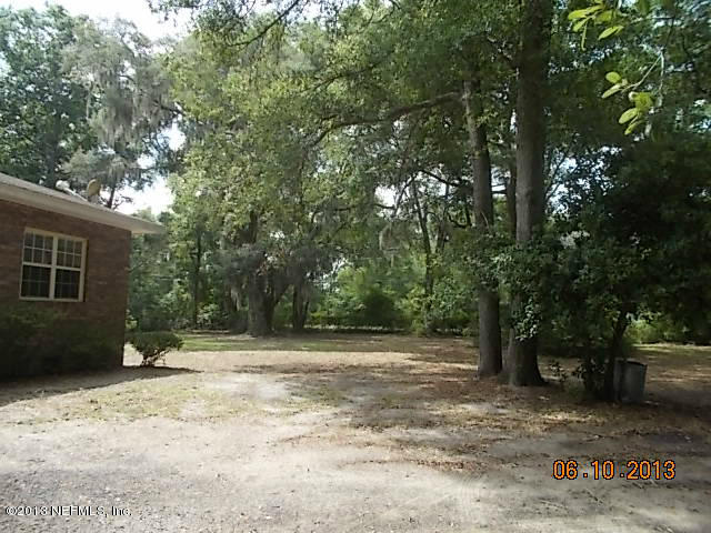 96539 Blackrock Road Yulee, FL 32097 - Photo 10 of 26 a backyard of a house with lots of green space
