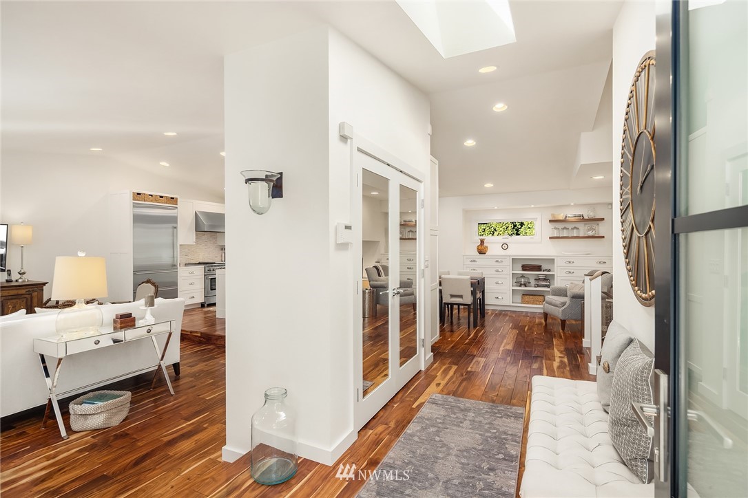 a living room with stainless steel appliances furniture and a table