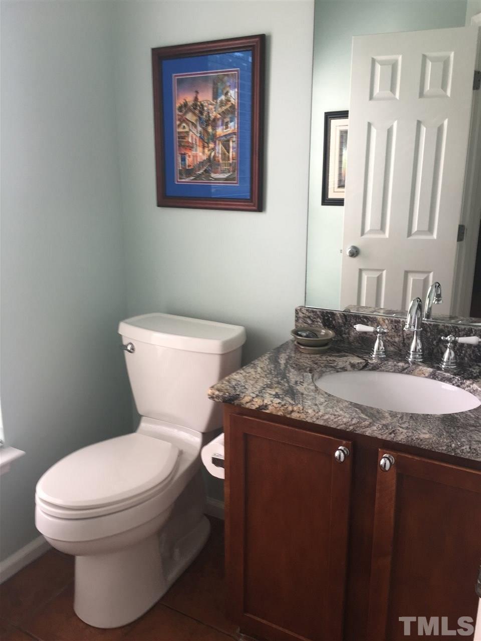 2614 Wyntercrest Lane Durham, NC 27713 - Photo 7 of 19 a bathroom with a granite countertop toilet sink and mirror