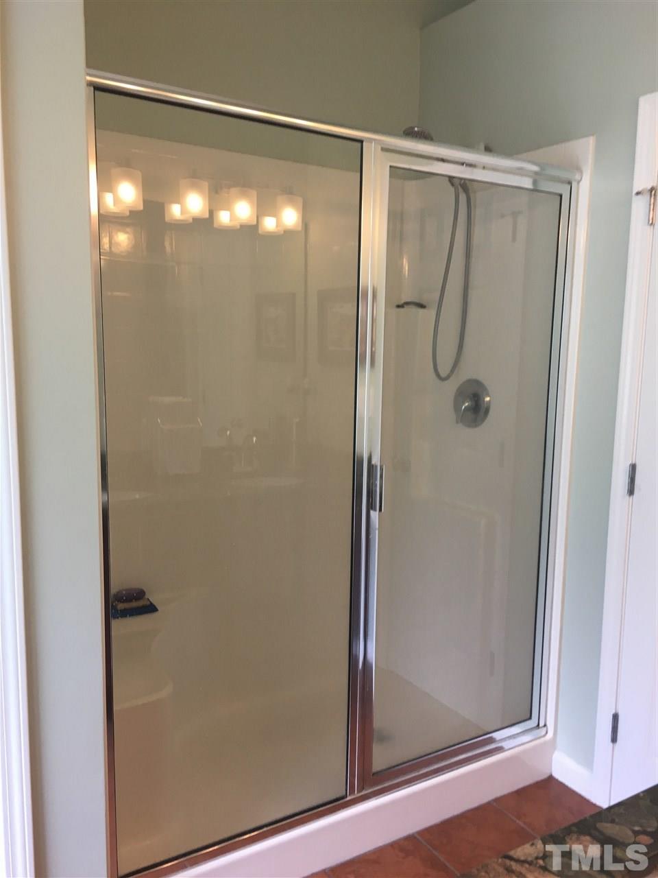 2614 Wyntercrest Lane Durham, NC 27713 - Photo 10 of 19 a bathroom with a glass shower door