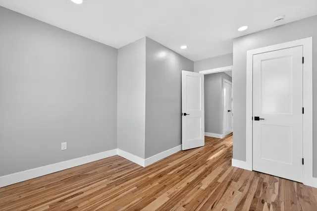 a view of a room with wooden floor