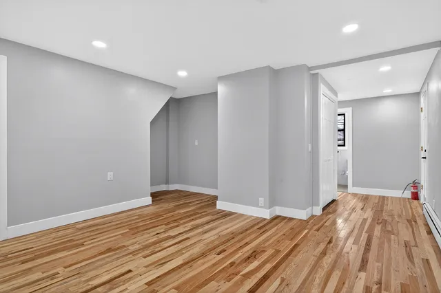 a view of hallway with wooden floor