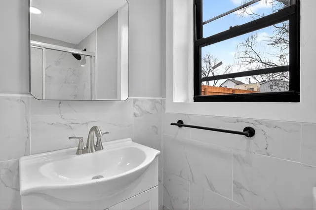 a bathroom with a sink and mirror