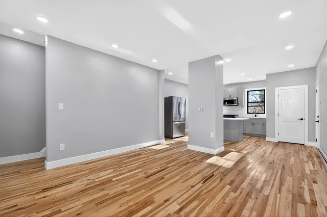 a view of a kitchen with wooden floor
