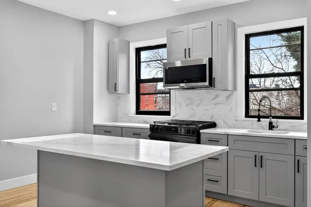 a kitchen with a sink stove and microwave