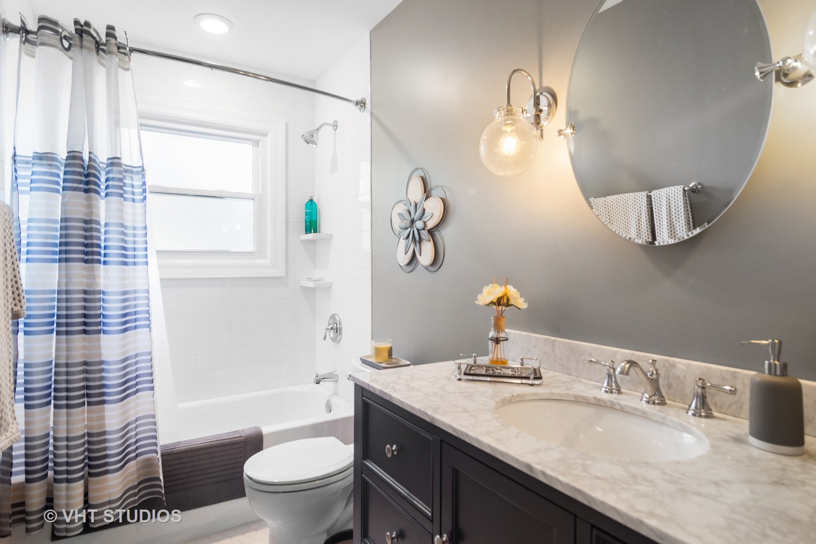 1857 Thomas Atkinson Road Inverness, IL 60067 - Photo 23 of 40 a bathroom with a granite countertop sink toilet a mirror and shower