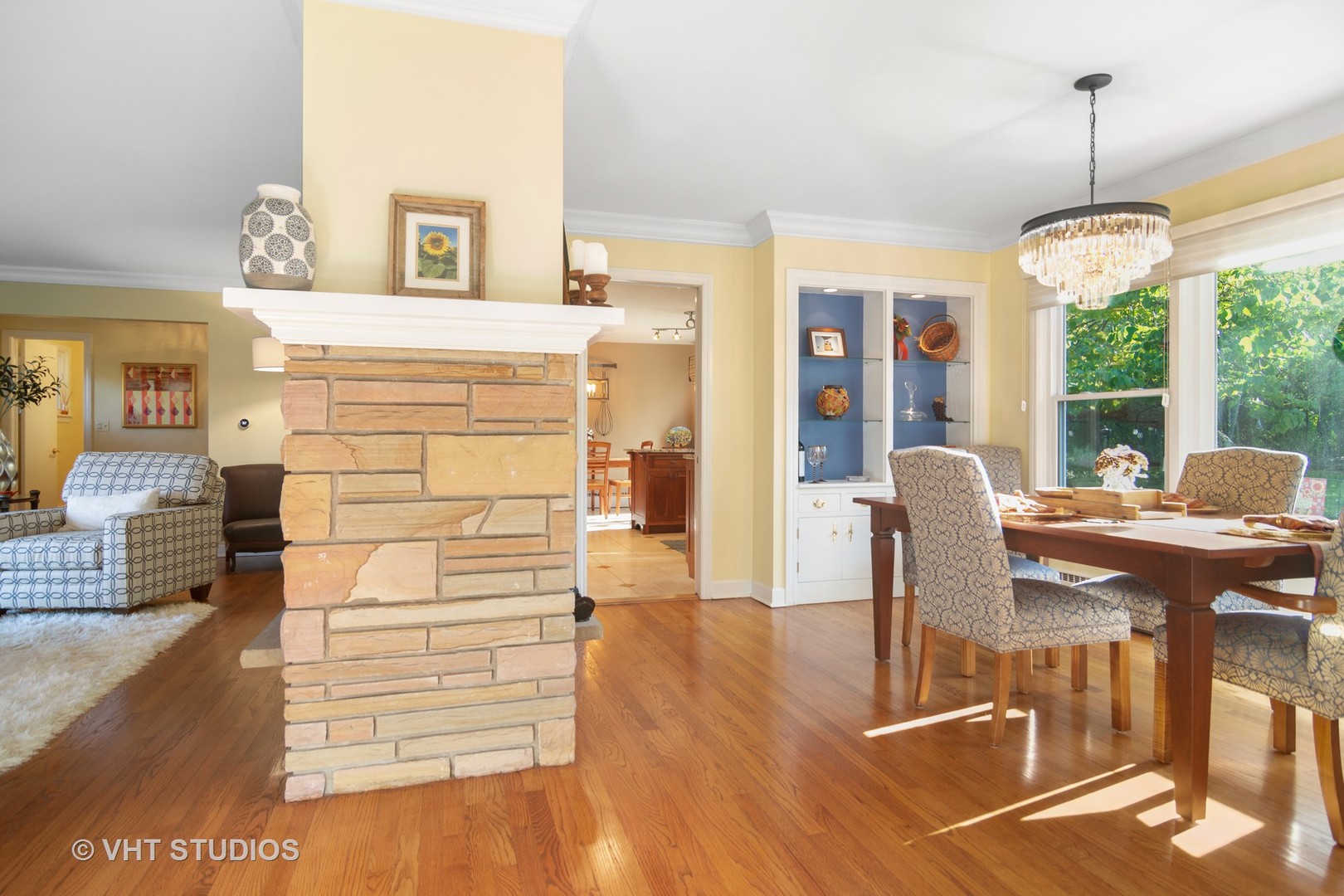 1857 Thomas Atkinson Road Inverness, IL 60067 - Photo 6 of 40 a view of a dining room and livingroom with furniture wooden floor a rug a flat screen tv a chandelier and a large window