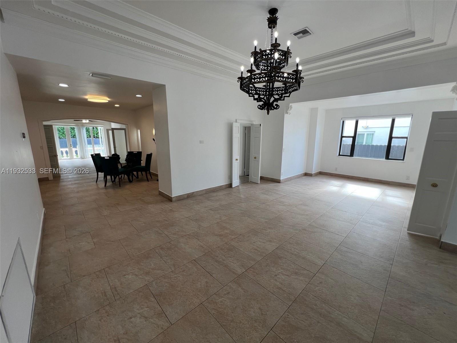 4575 Post Avenue Miami Beach, FL 33140 - Photo 17 of 57 a view of living room filled with furniture and chandelier