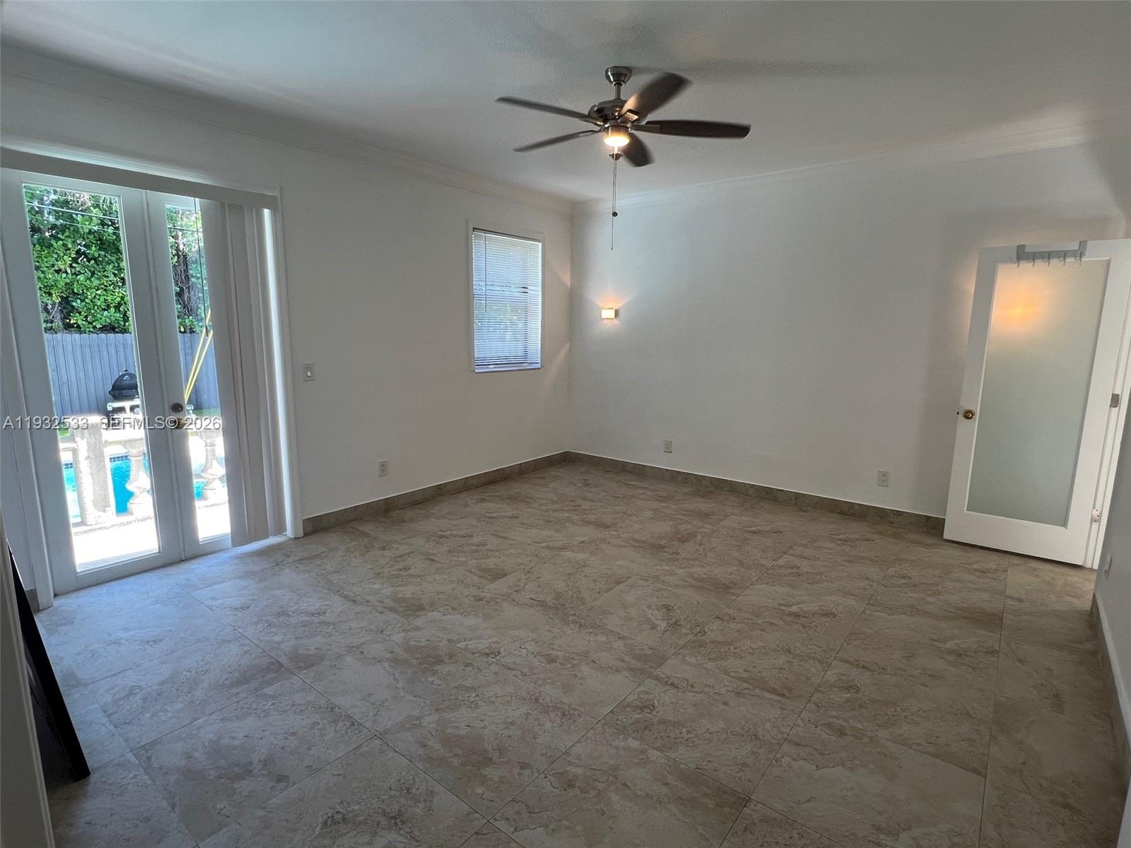 4575 Post Avenue Miami Beach, FL 33140 - Photo 24 of 57 an empty room with windows and ceiling fan