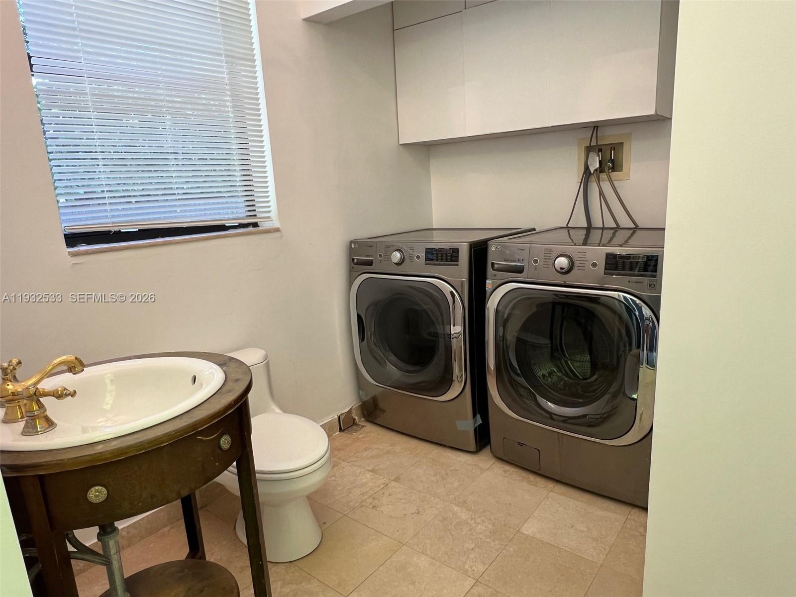 4575 Post Avenue Miami Beach, FL 33140 - Photo 34 of 57 a bathroom with a sink a toilet and a mirror