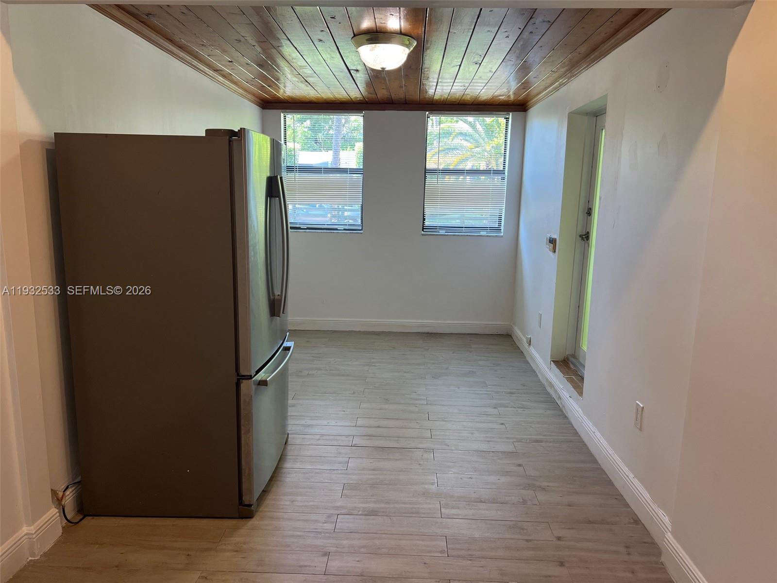 4575 Post Avenue Miami Beach, FL 33140 - Photo 36 of 57 an empty room with wooden floor and windows