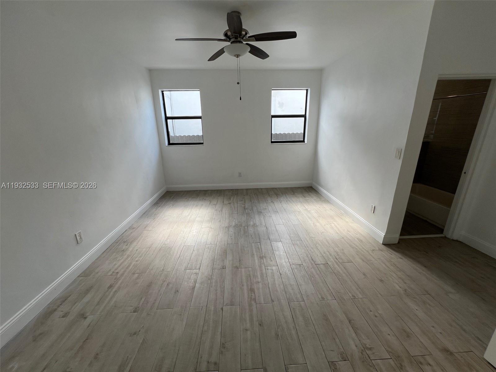 4575 Post Avenue Miami Beach, FL 33140 - Photo 43 of 57 an empty room with wooden floor and windows