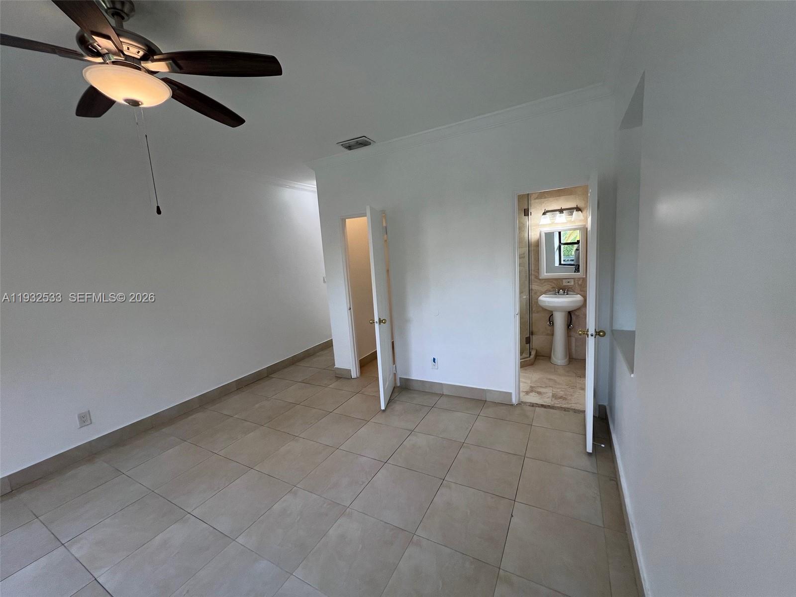 4575 Post Avenue Miami Beach, FL 33140 - Photo 45 of 57 an empty room with ceiling fan and window