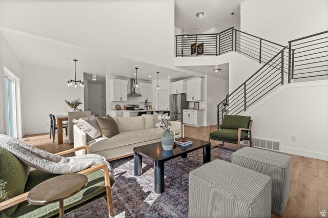 14728 South Canyon Pointe Road Draper, UT 84020 - Photo 6 of 35 Open-concept living space with wood-finish flooring, a contemporary staircase featuring horizontal metal railings, and recessed lighting